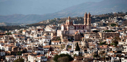 A panoramic view of Taxco, showcasing its historic architecture and mountainous backdrop.