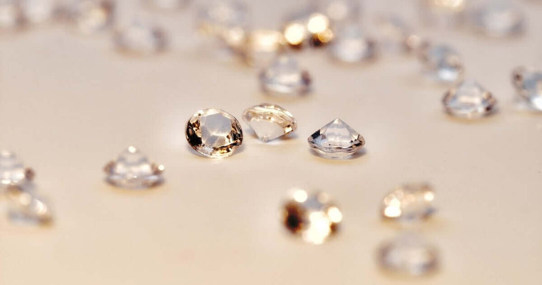 loose diamonds on a tan background
