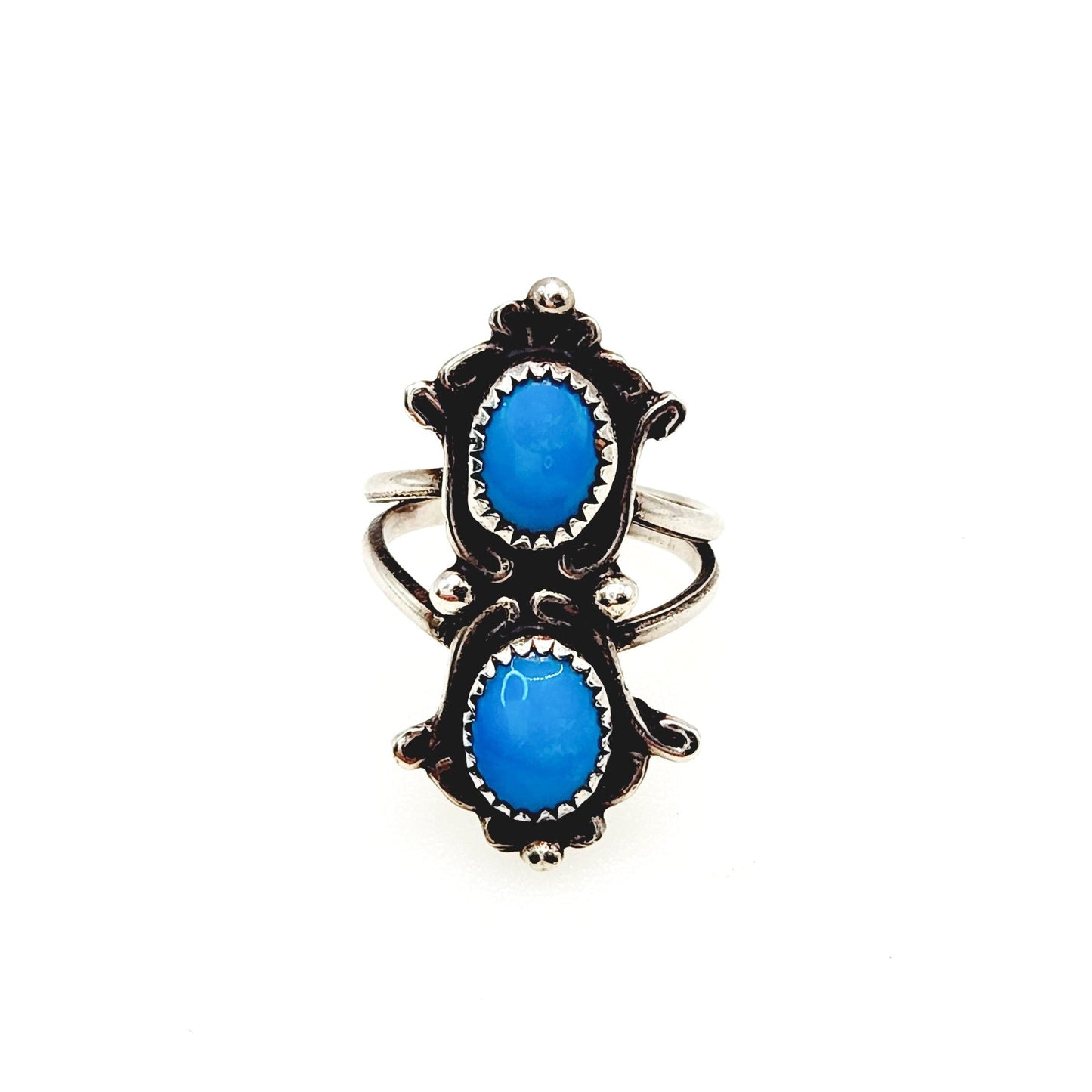 A vintage 1990s blue turquoise cabochon and sterling silver pinky ring, featuring two oval-shaped stones on a band.
