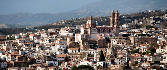 A panoramic view of Taxco, showcasing its historic architecture and mountainous backdrop.