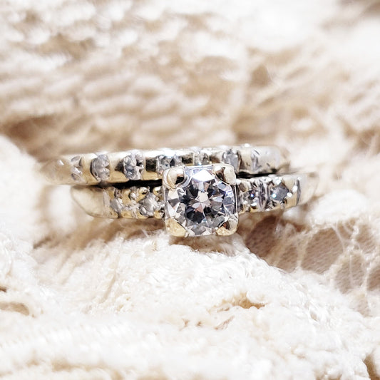 a wedding set from the 1930s with round cut diamonds in white gold on tan lace