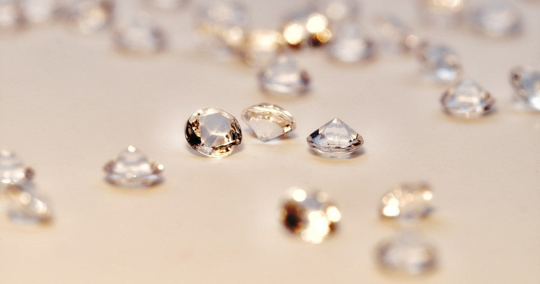 loose diamonds on a tan background