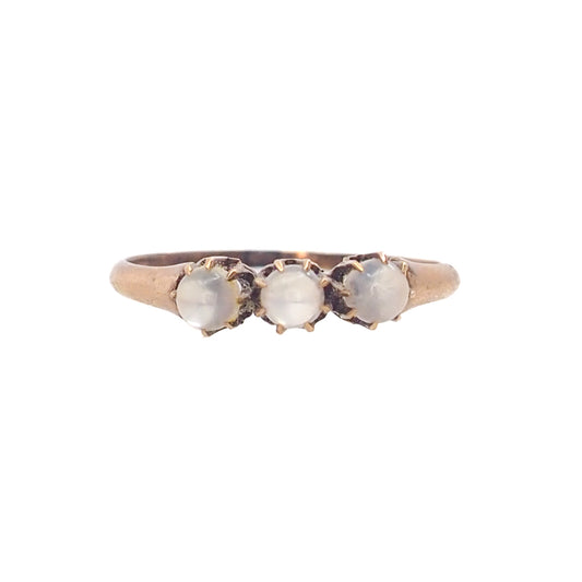 Three-stone ring with moonstones on a white background