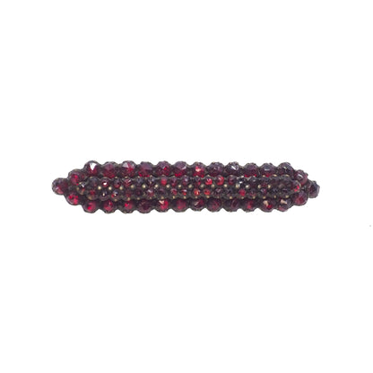 Red beaded hair clip on a white background