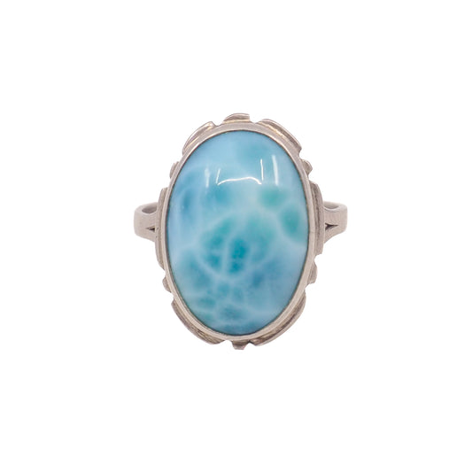 large blue gemstone in silver ring