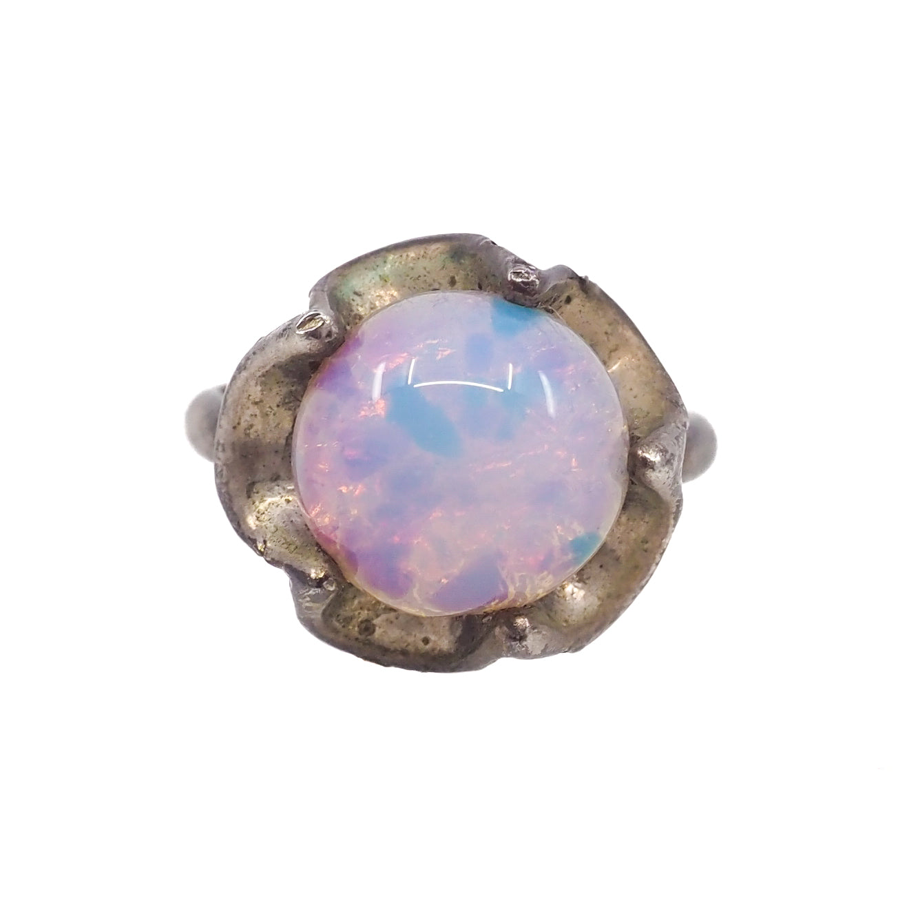 Ring with a round opal stone and metallic band on a white background