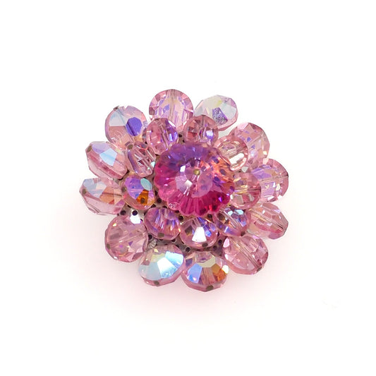 a round brooch with pink beads