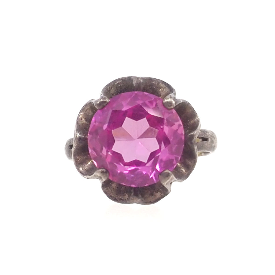large silver ring with round pink glass