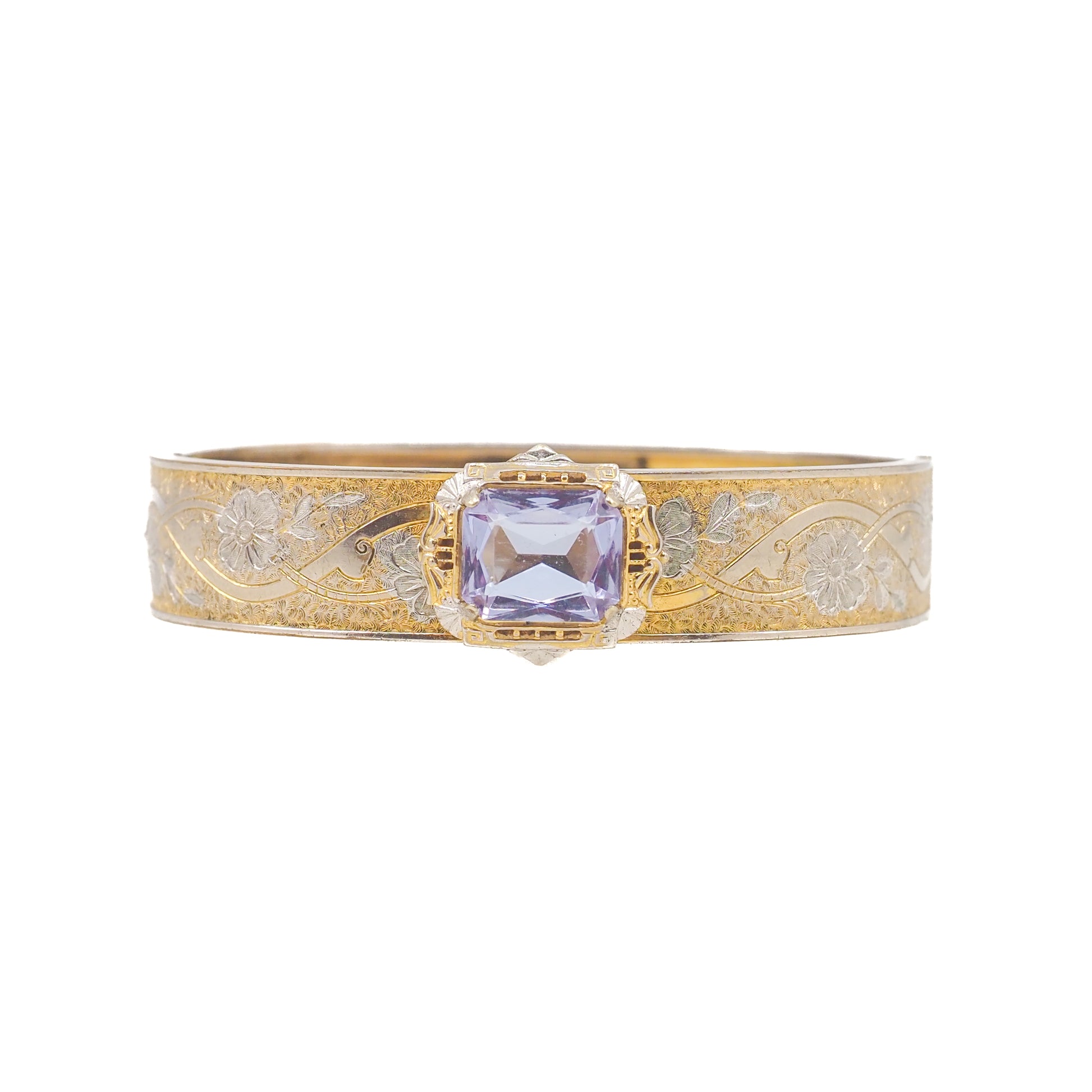 Gold bracelet with a purple gemstone on a white background