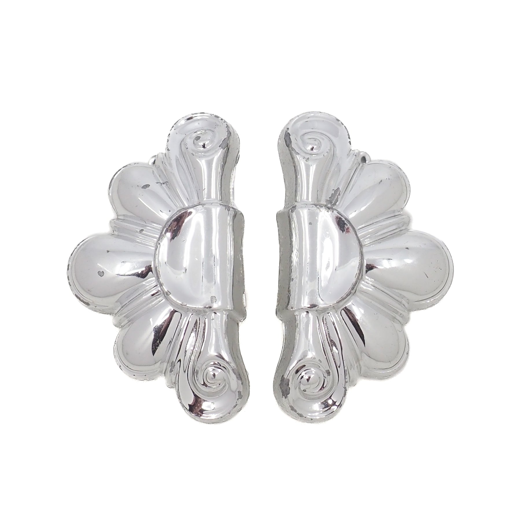 Pair of silver floral earrings on a white background