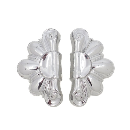 Pair of silver floral earrings on a white background