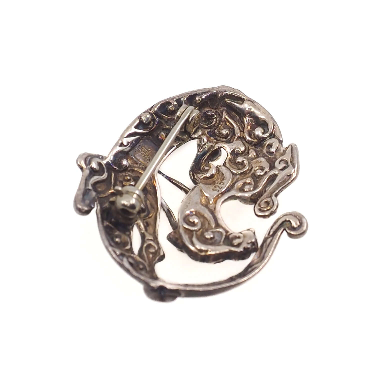 The back of a Sleeping Dragon Animal Figural Sterling Silver Brooch